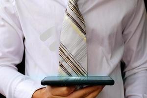 Businessman using a smartphone and technology network concepts photo