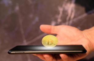 Bitcoin cryptocurrency coin and euro coin on smartphone, concept photo