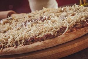 Pizza with mozzarella, beef stroganoff and potato sticks photo