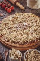 Pizza with mozzarella, beef stroganoff and potato sticks photo