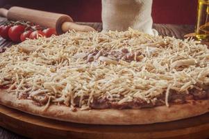 Pizza with mozzarella, beef stroganoff and potato sticks photo