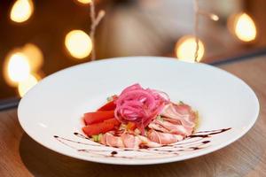 A photo of a mint and dolendwitz salad in a restaurant on the table