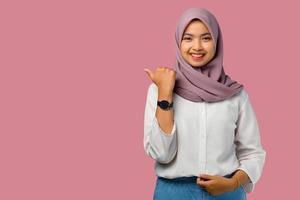 Woman wearing a hijab on a pink background