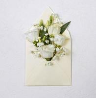 A bouquet of Eustoma in a white envelope, delicate Japanese roses photo
