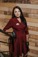 A female restaurant manager in black disposable gloves posing in a coffee shop photo