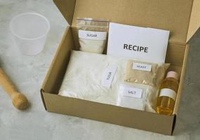 A set of ingredients for baking homemade bread, including wholewheat flour, salt, sugar, sunflower or olive oil, and yeast photo