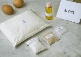 A set of ingredients for baking homemade bread, including wholewheat flour, salt, sugar, sunflower or olive oil, and yeast photo