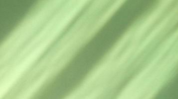 Diagonal shadows on pastel green paper abstract background photo
