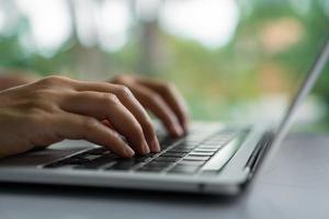 A hand using a laptop computer searching for information on the internet photo