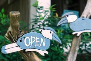 A business sign that says open on a cafe or restaurant hanging door entrance photo