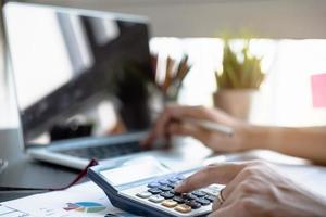 Close-up of a person using a calculator photo