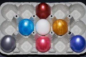 Pearly-colored Easter eggs in an egg carton