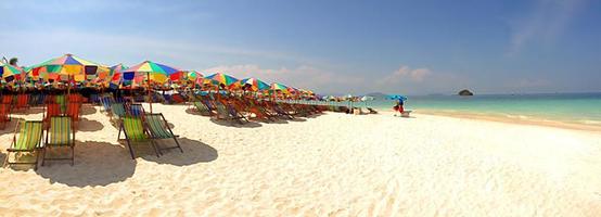 Panorama de coloridas sombrillas y sillones en la playa