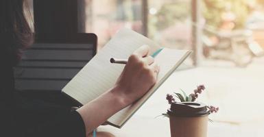 Woman writing in a notebook photo