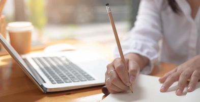 Close-up of a person writing with a pencil photo