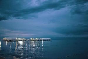 Twilight landscape of pier stretching out into sea photo