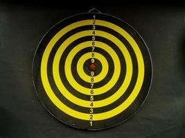Yellow and black dartboard photo