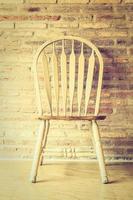 Wooden chair at the wall photo