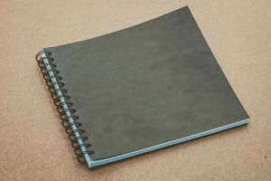 Notebook mock up on wood background photo