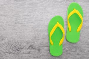 Flip flop on wooden background photo