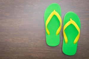 Flip flop on wooden background photo