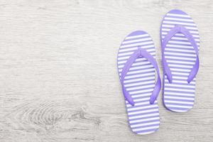 Flip flop on wooden background photo