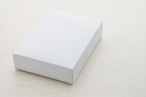 Paper box on wood background photo