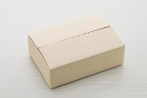 Paper box on wood background photo