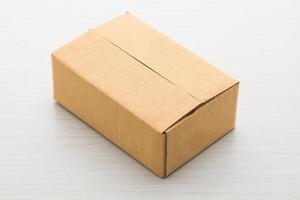 Paper box on wood background photo