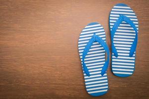 Flip flop on wooden background photo