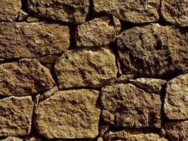 Primer plano de la pared de piedra o roca de fondo o textura foto