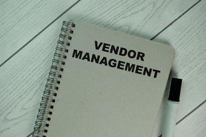 Vendor Management book isolated on wooden table photo