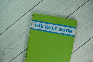 Rule Book isolated on wooden table photo