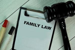 Family law written on paperwork with gavel isolated on wooden table photo