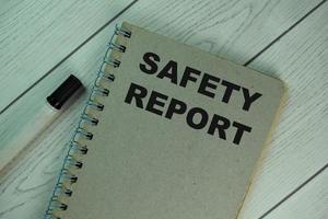 Safety report notepad isolated on wooden table photo