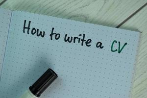 How to write a CV written a in a book isolated on wooden table photo