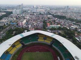 Bekasi, Indonesia 2021- Aerial view of the largest stadium of Bekasi from a drone with sunset and clouds photo