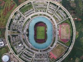 Bogor, Indonesia 2021- Aerial view of the largest stadium Pakansari Stadium from drone with clouds and sunset photo