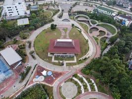 Depok, Indonesia 2021- Aerial view of playground yard in public park surrounded by green trees photo