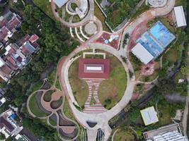 Depok, Indonesia 2021- Aerial view of playground yard in public park surrounded by green trees photo