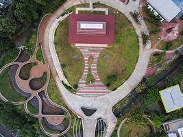 Depok, Indonesia 2021- Aerial view of playground yard in public park surrounded by green trees photo