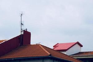 Antenna tv on the rooftop of a house photo