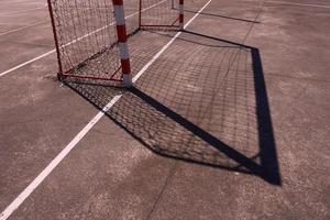 Street soccer goal shadow on the field photo