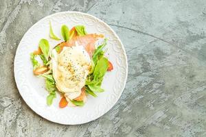Poached eggs with salmon and rocket salad photo