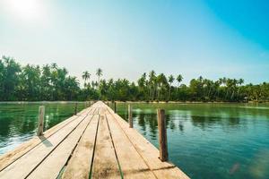 Wood bridge or pier on the beach and sea photo