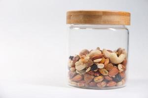 Jar of mixed nuts isolated on white background photo