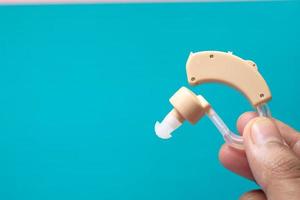 Hearing aid on blue background photo