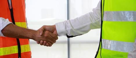 Handshake of engineers in the construction site photo