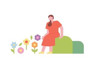 A woman is sitting on a small hill and looking at the flowers. vector