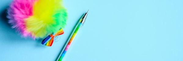 Multi-colored pen on blue background photo